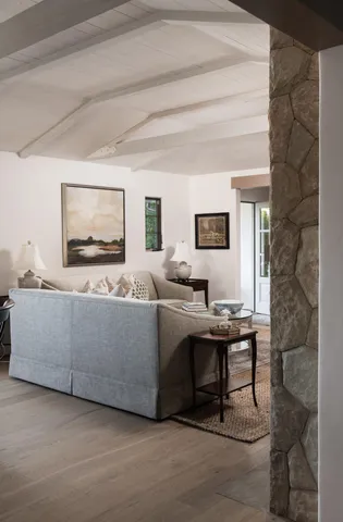 a living room with furniture a window and a flat screen tv