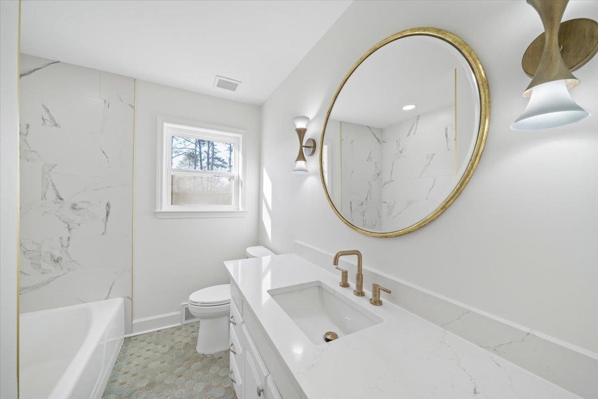 1676 Miller Farms Road Germantown, TN 38138 - Photo 17 of 37 Bathroom featuring a white vanity with an integrated rectangular sink and brass-finish fixtures
