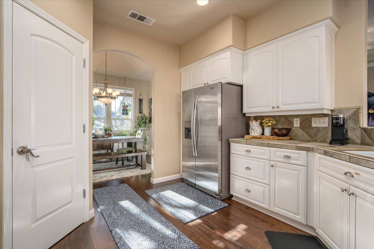 2122 Edinburgh Way Redding, CA 96003 - Photo 15 of 61 a kitchen with stainless steel appliances a refrigerator and cabinets