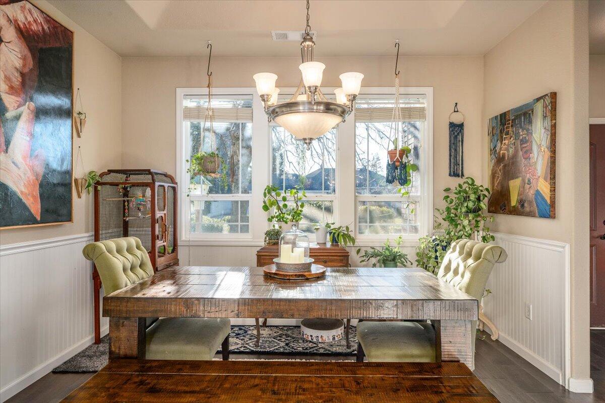 2122 Edinburgh Way Redding, CA 96003 - Photo 16 of 61 a view of a dining room with furniture wooden floor and chandelier