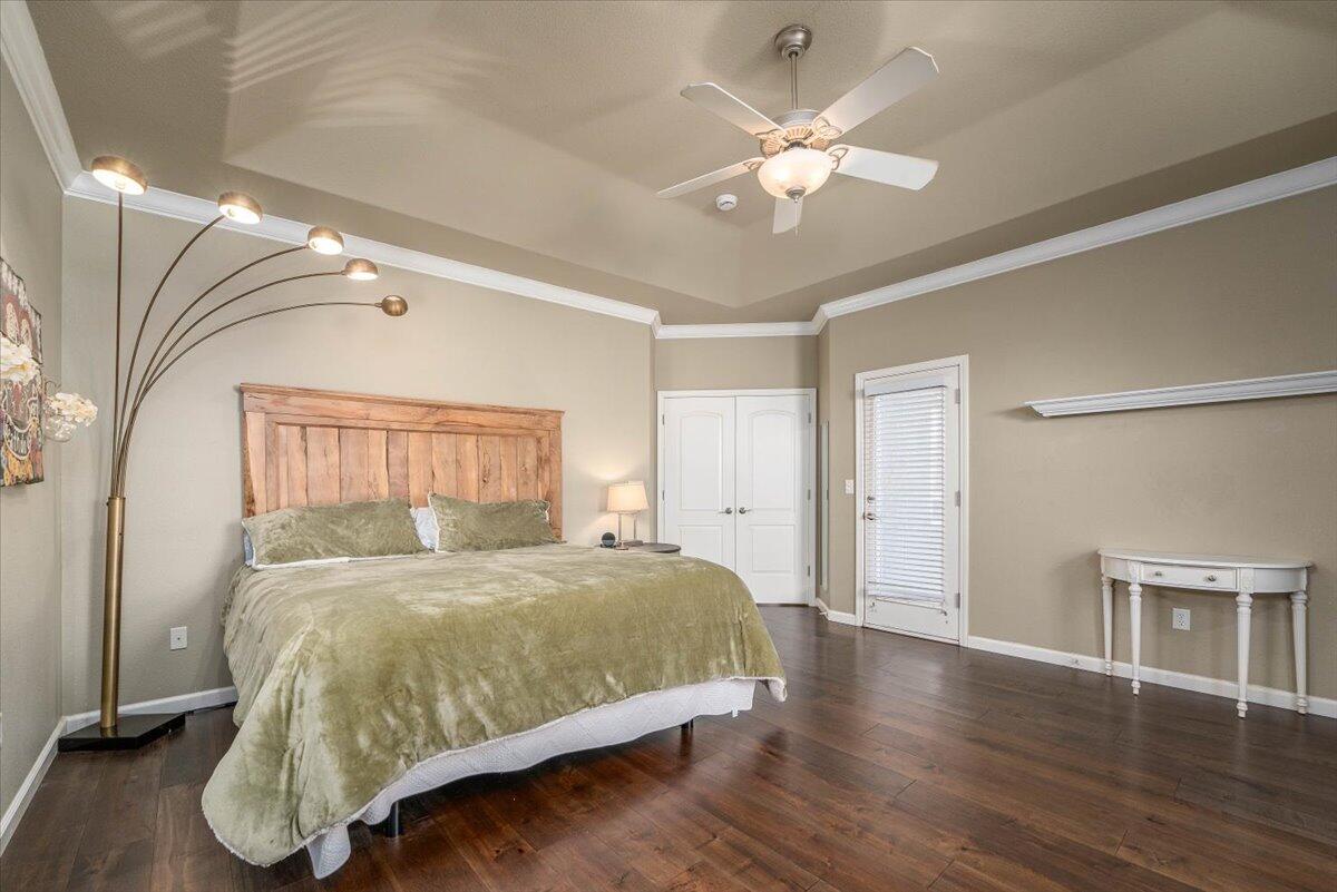 2122 Edinburgh Way Redding, CA 96003 - Photo 17 of 61 a bedroom with a large bed chandelier and a window