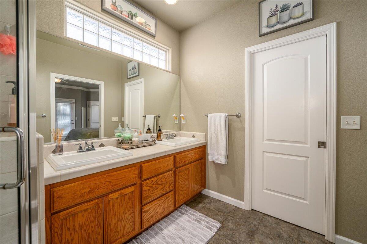 2122 Edinburgh Way Redding, CA 96003 - Photo 20 of 61 a bathroom with a double vanity sink and mirror