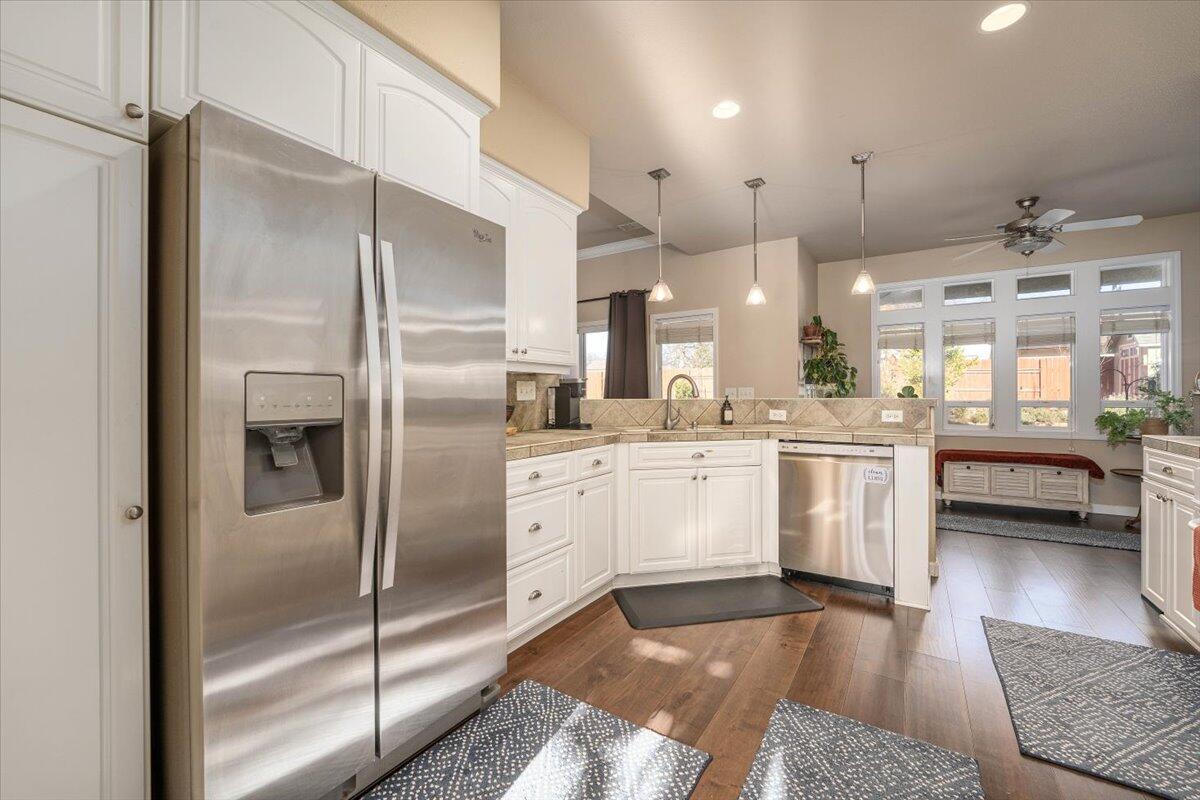 2122 Edinburgh Way Redding, CA 96003 - Photo 2 of 61 a kitchen with white cabinets and refrigerator