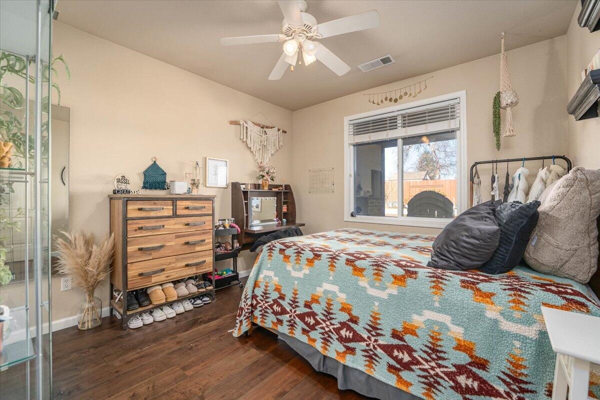 2122 Edinburgh Way Redding, CA 96003 - Photo 22 of 61 a bedroom with a bed and a chandelier