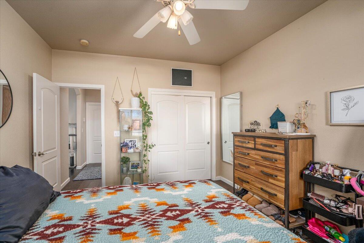 2122 Edinburgh Way Redding, CA 96003 - Photo 23 of 61 a bedroom with a bed and a chandelier