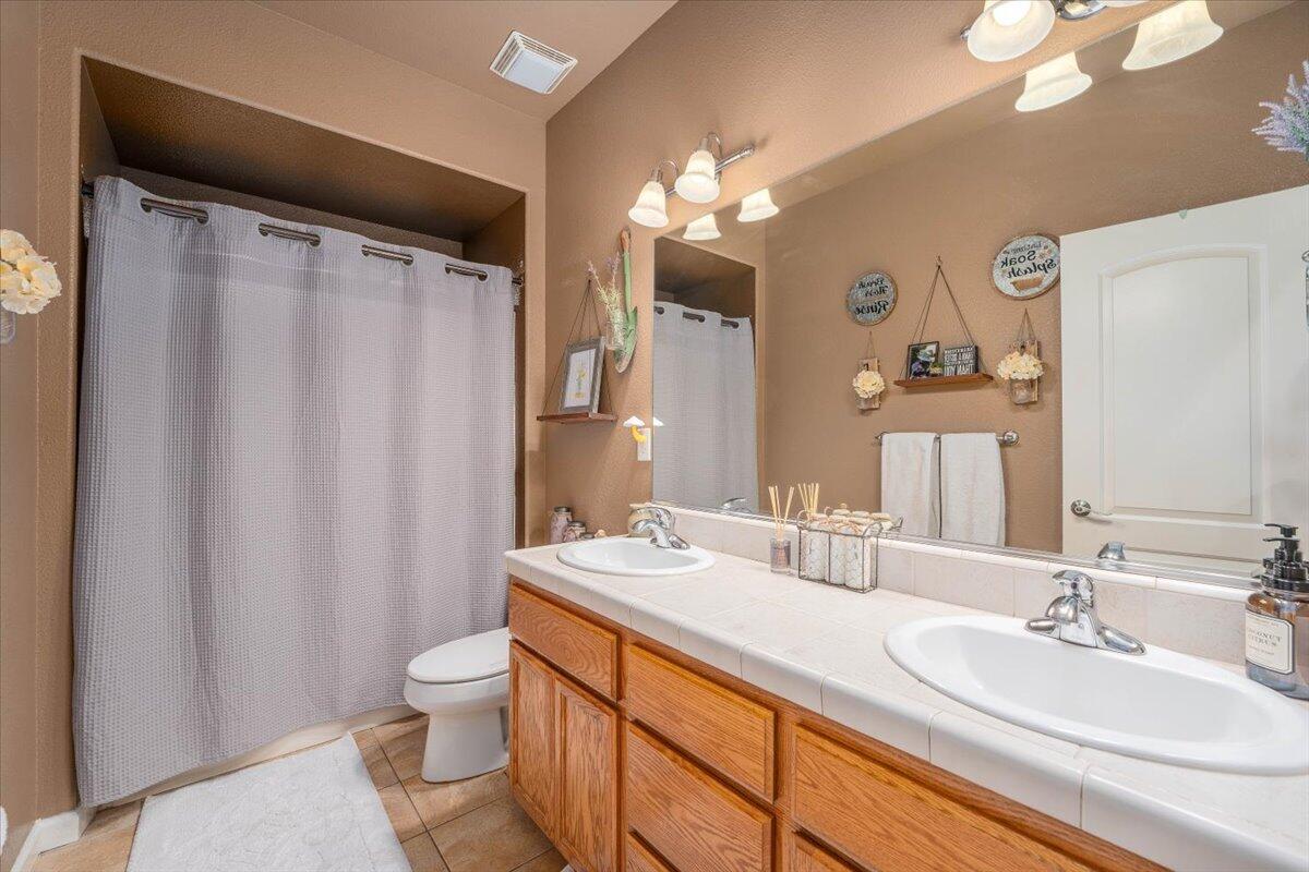 2122 Edinburgh Way Redding, CA 96003 - Photo 24 of 61 a bathroom with a double vanity sink mirror and toilet