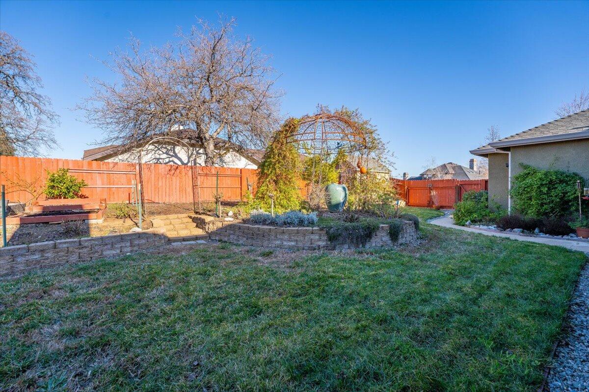 2122 Edinburgh Way Redding, CA 96003 - Photo 32 of 61 a view of a house with a big yard and a large tree