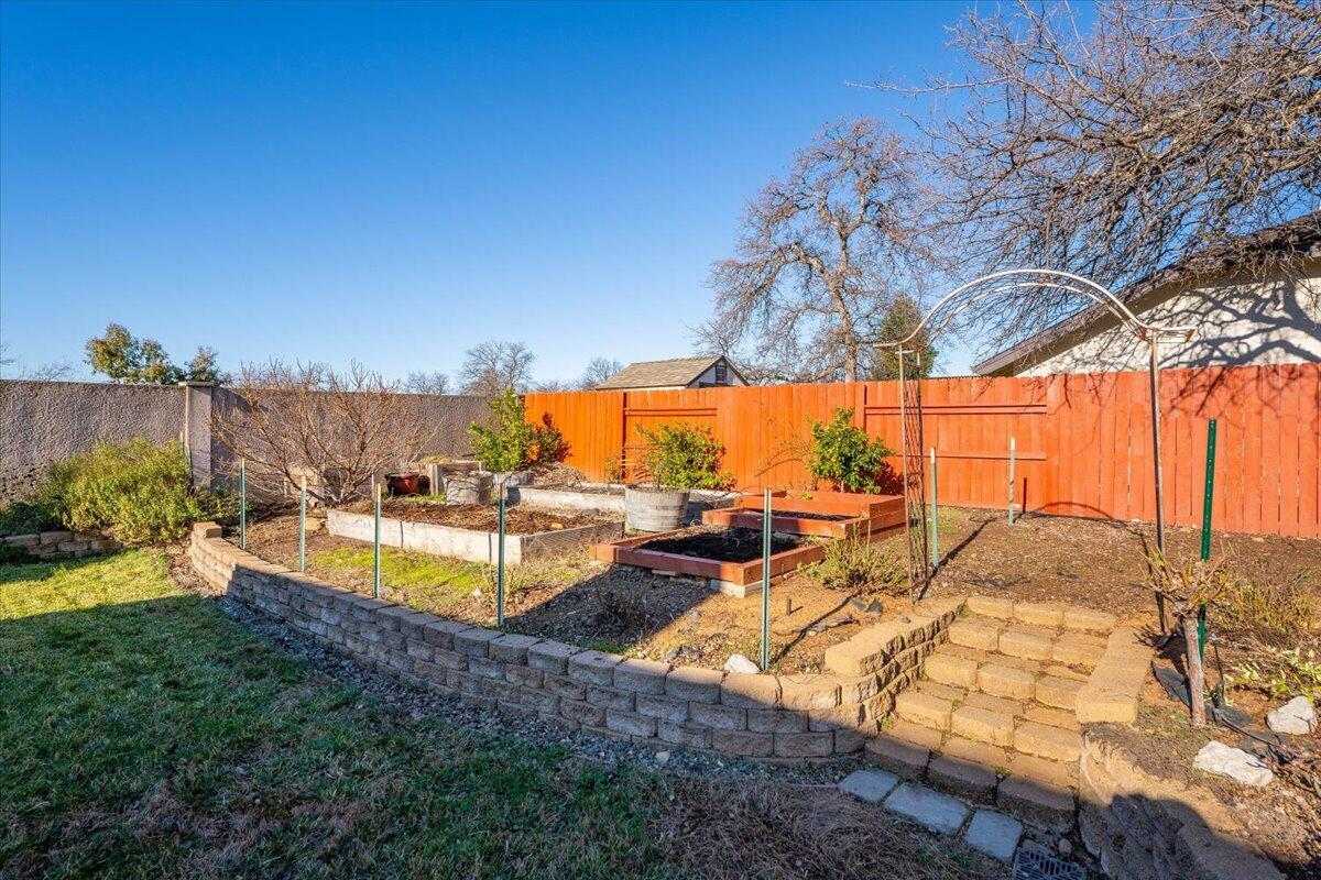 2122 Edinburgh Way Redding, CA 96003 - Photo 36 of 61 a view of swimming pool with outdoor seating and a garden