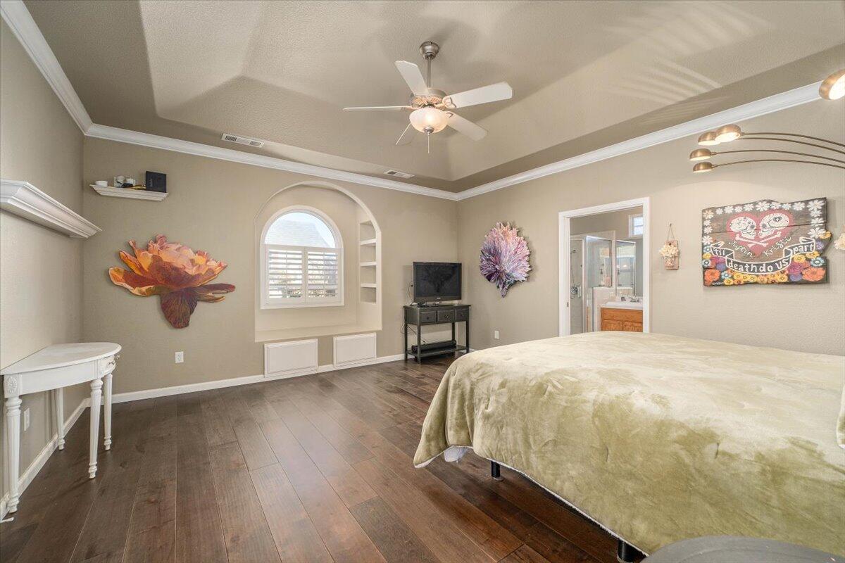 2122 Edinburgh Way Redding, CA 96003 - Photo 4 of 61 a bedroom with a large bed and a chandelier