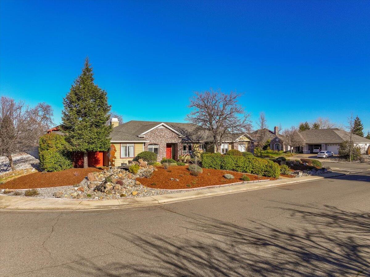 2122 Edinburgh Way Redding, CA 96003 - Photo 44 of 61 a front view of a house with a yard and a garage