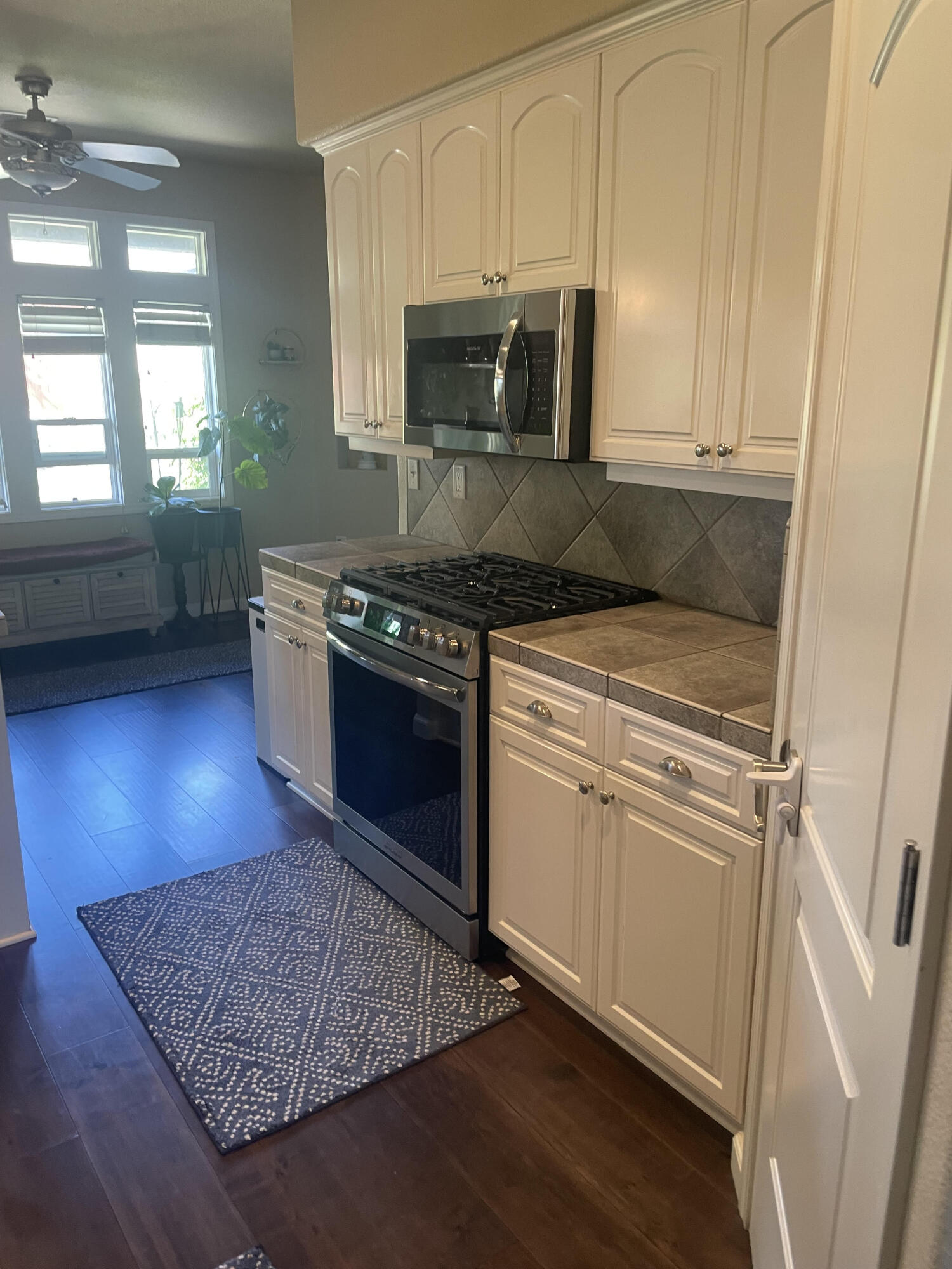 2122 Edinburgh Way Redding, CA 96003 - Photo 6 of 61 a kitchen with stainless steel appliances granite countertop a stove a sink and a microwave