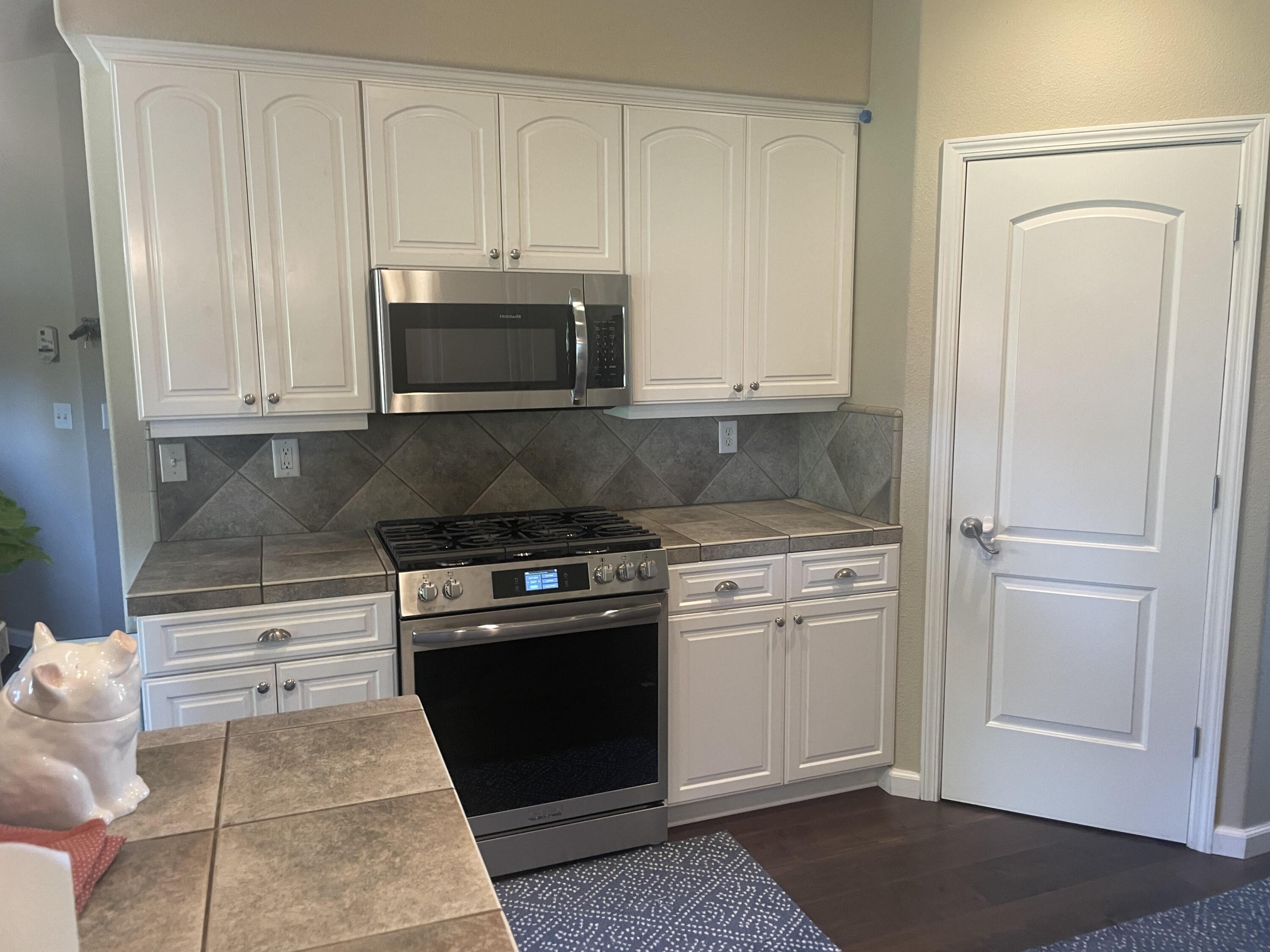 2122 Edinburgh Way Redding, CA 96003 - Photo 7 of 61 a kitchen with granite countertop white cabinets and stainless steel appliances