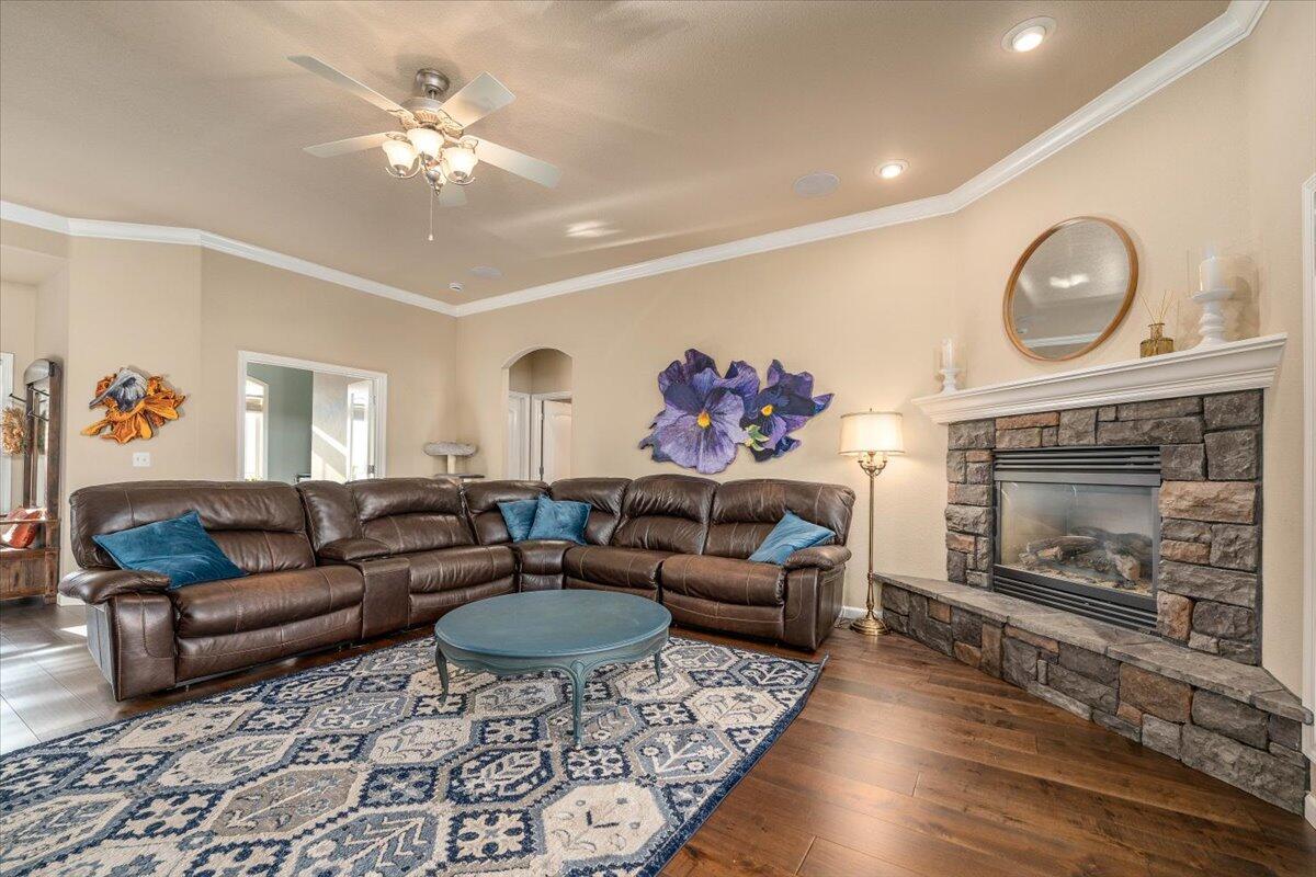 2122 Edinburgh Way Redding, CA 96003 - Photo 9 of 61 a living room with furniture a fireplace and a chandelier