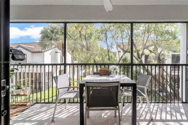a view of a two chairs and table in the balcony