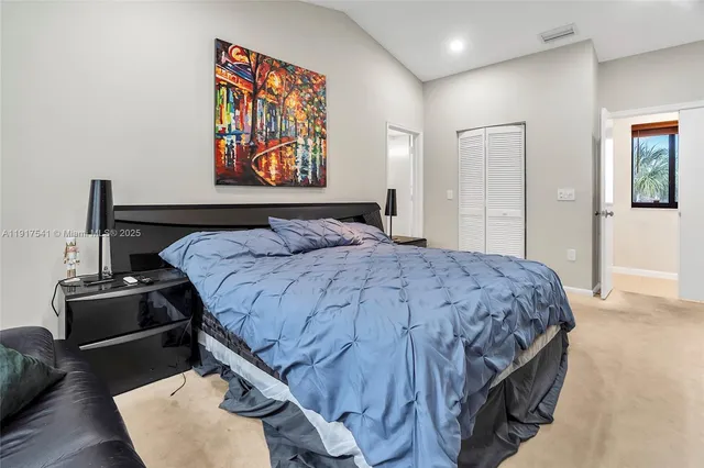 a bedroom with a bed and dresser