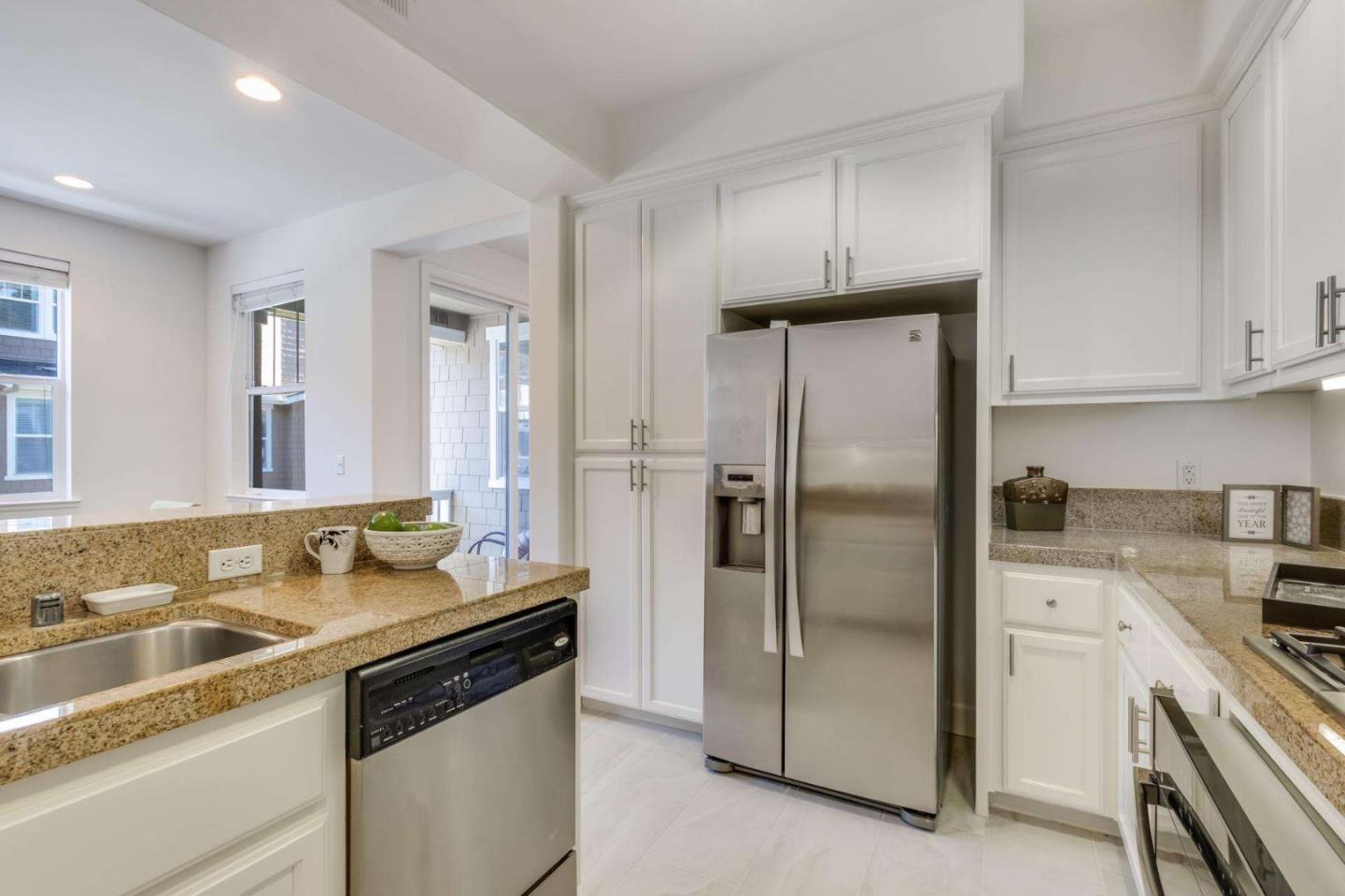100 Live Oak Way, Unit 104 Belmont, CA 94002 - Photo 16 of 37 a kitchen with stainless steel appliances granite countertop a sink stove and refrigerator