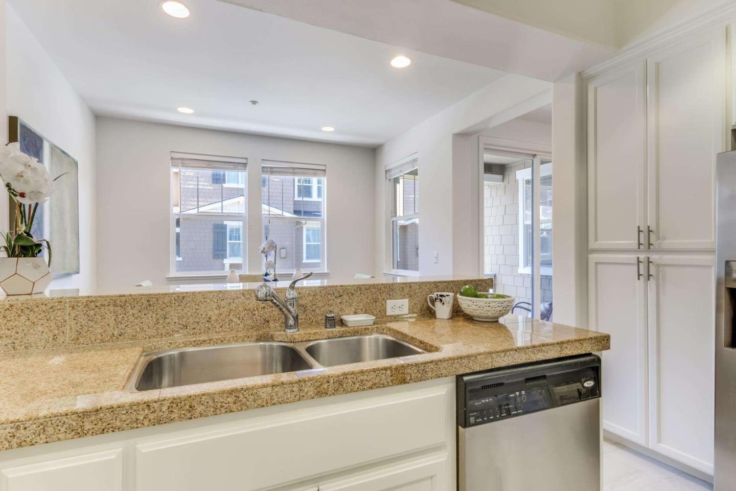 100 Live Oak Way, Unit 104 Belmont, CA 94002 - Photo 17 of 37 a close view of a sink and a large mirror in a room