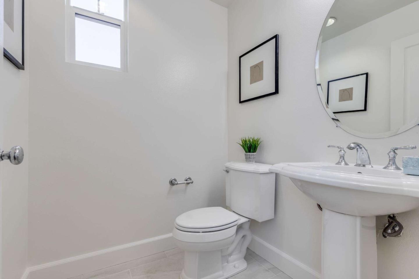 100 Live Oak Way, Unit 104 Belmont, CA 94002 - Photo 18 of 37 a bathroom with a sink toilet and a mirror
