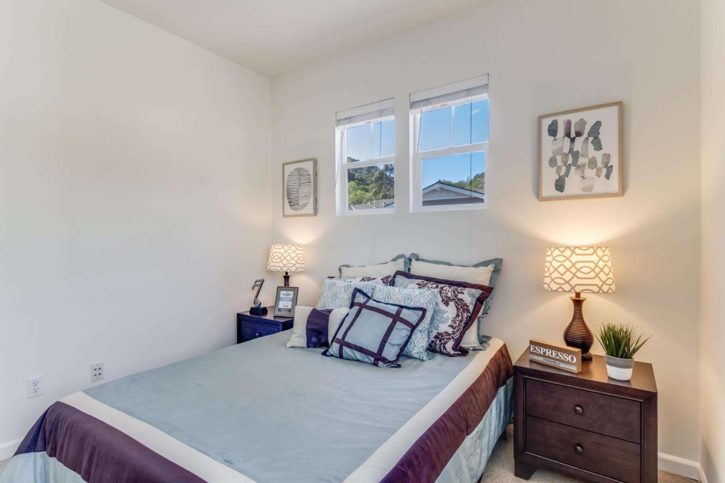 100 Live Oak Way, Unit 104 Belmont, CA 94002 - Photo 20 of 37 a bedroom with a bed and a lamp on dresser