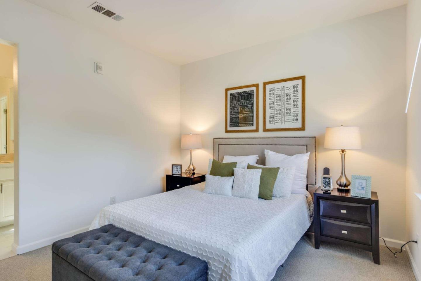 100 Live Oak Way, Unit 104 Belmont, CA 94002 - Photo 25 of 37 a bedroom with a bed and a lamp