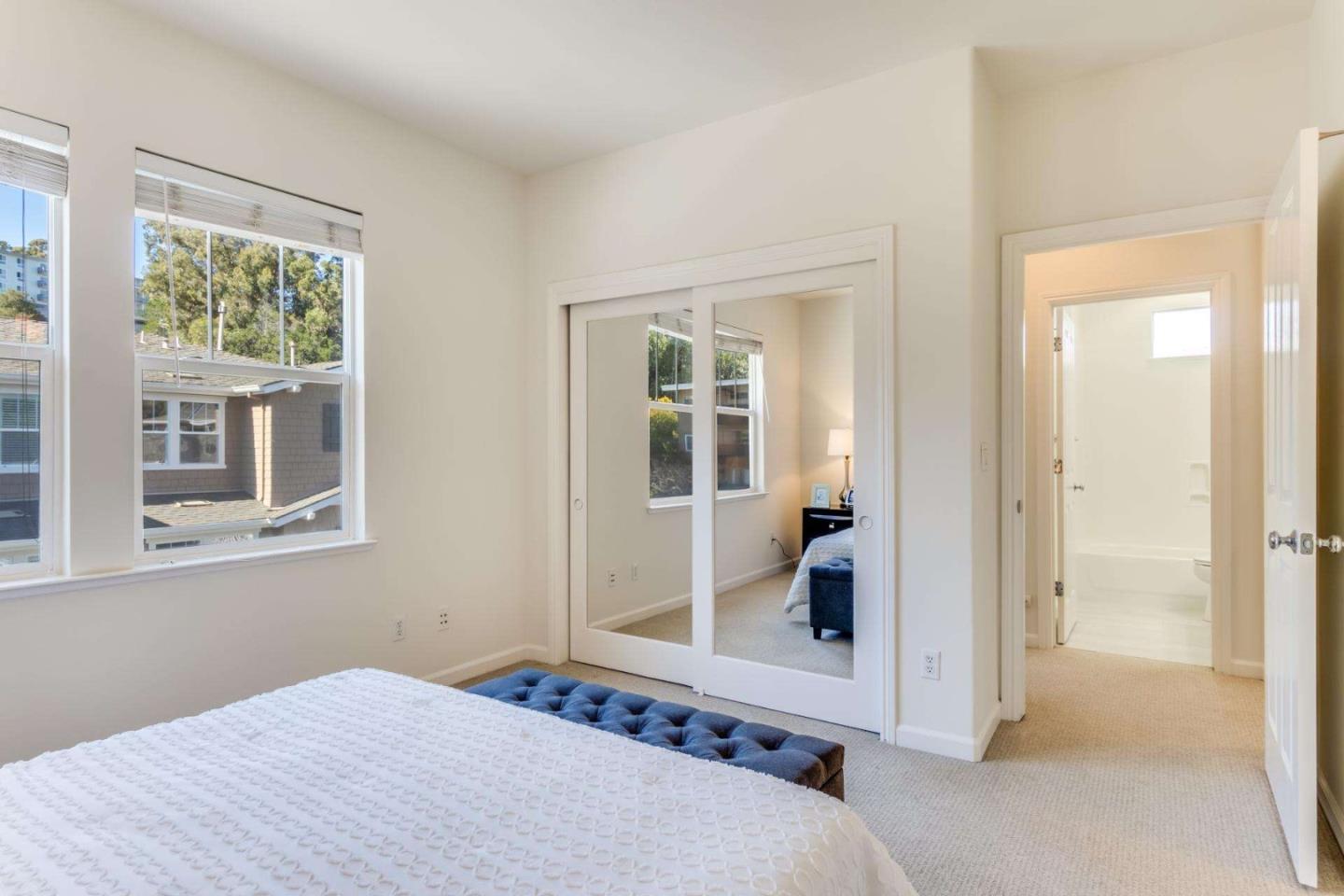 100 Live Oak Way, Unit 104 Belmont, CA 94002 - Photo 27 of 37 a bedroom with a bed and a window