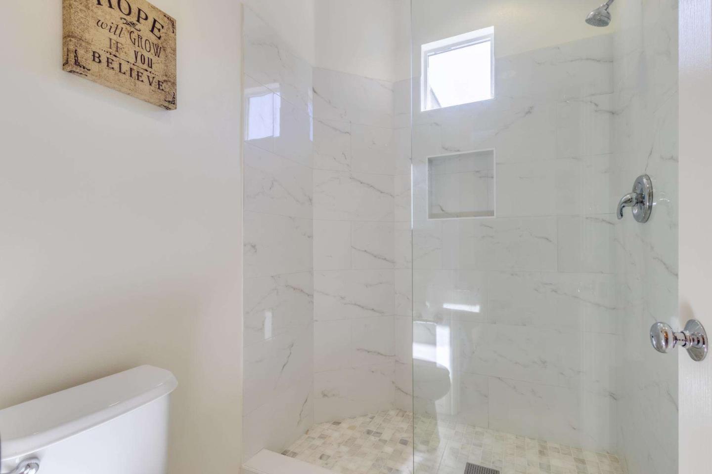 100 Live Oak Way, Unit 104 Belmont, CA 94002 - Photo 29 of 37 a bathroom with a shower and toilet