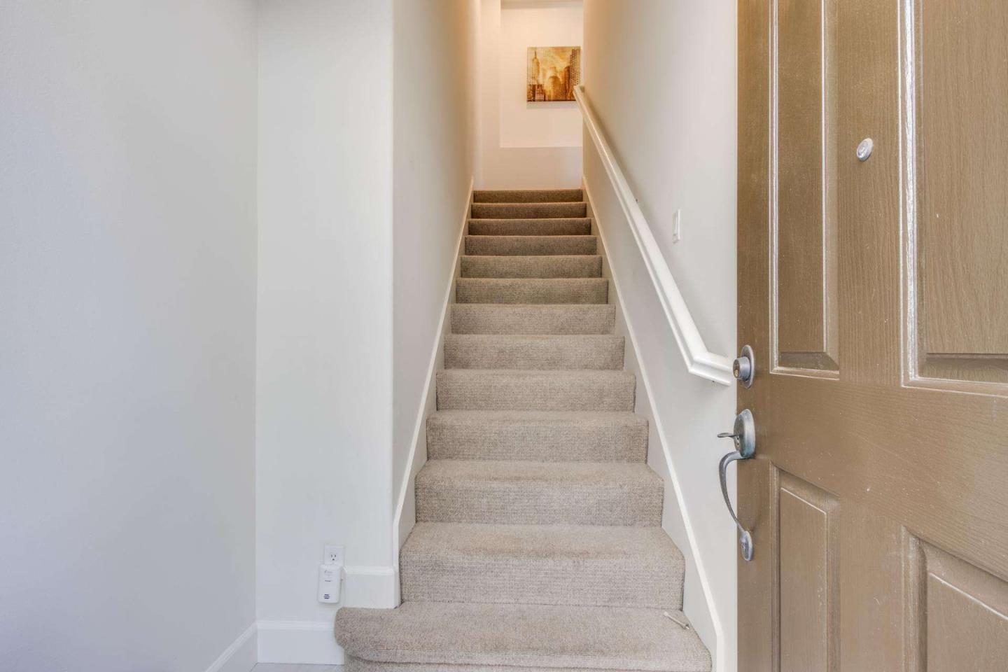 100 Live Oak Way, Unit 104 Belmont, CA 94002 - Photo 3 of 37 a view of staircase with white walls and white door