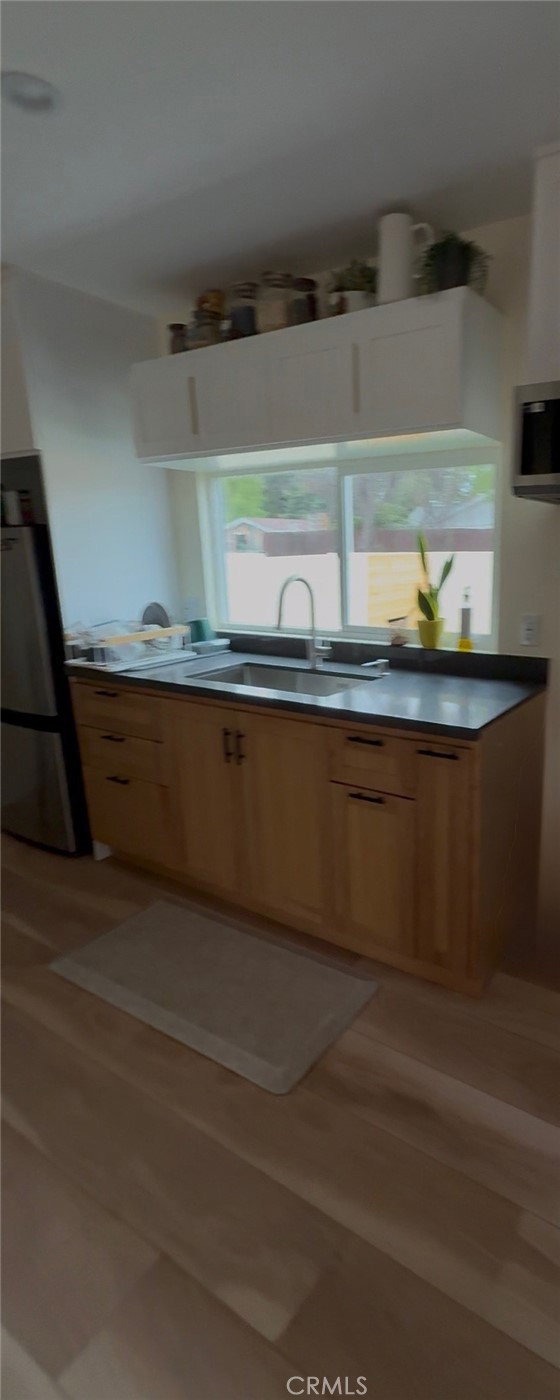 18727 Bassett Street Reseda, CA 91335 - Photo 3 of 8 a close view of sink and cabinets