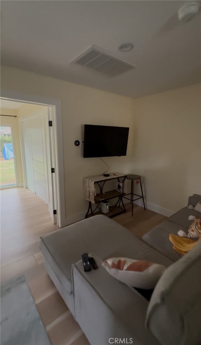 18727 Bassett Street Reseda, CA 91335 - Photo 5 of 8 a living room with furniture and a flat screen tv