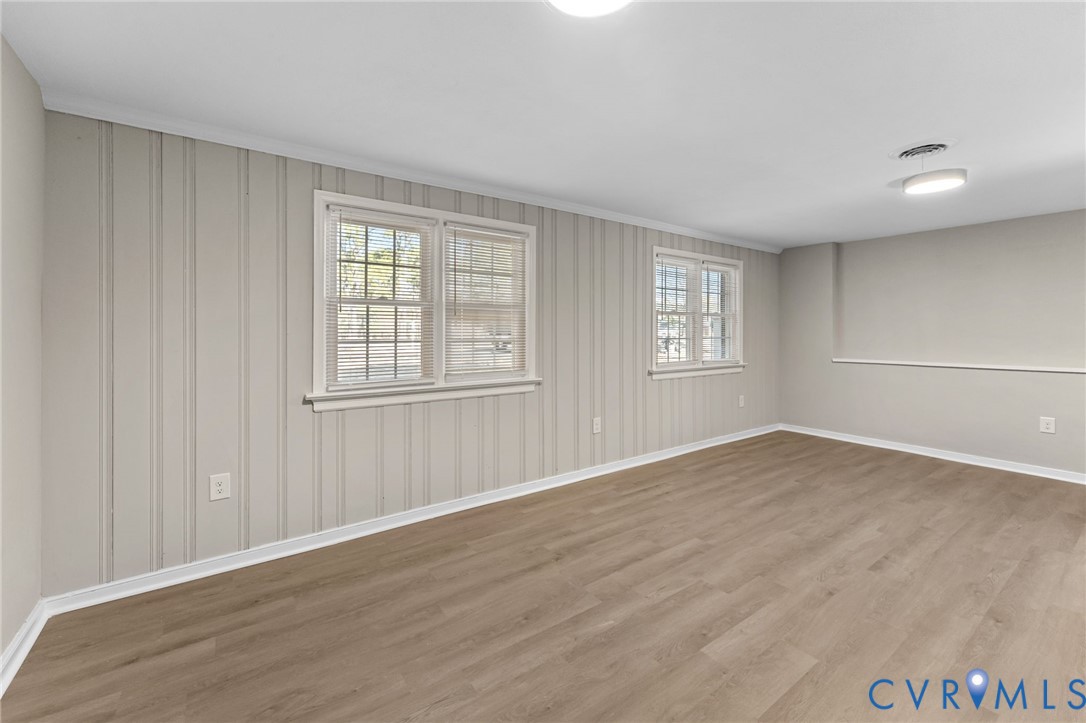 8005 Three Chopt Road Henrico, VA 23229 - Photo 11 of 28 a view of an empty room with wooden floor and a window