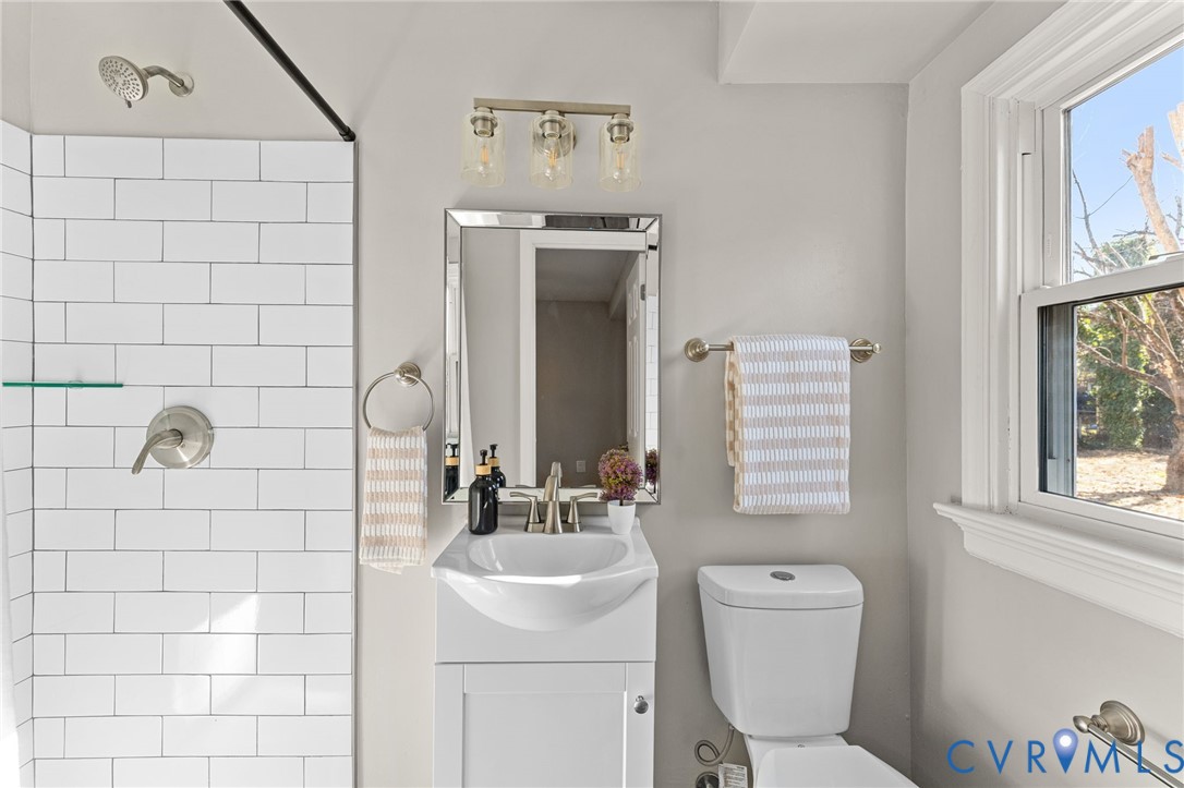 8005 Three Chopt Road Henrico, VA 23229 - Photo 14 of 28 a bathroom with a toilet sink and mirror