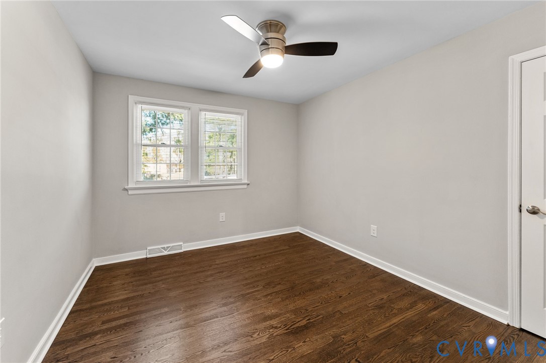 8005 Three Chopt Road Henrico, VA 23229 - Photo 16 of 28 an empty room with wooden floor ceiling fan and windows