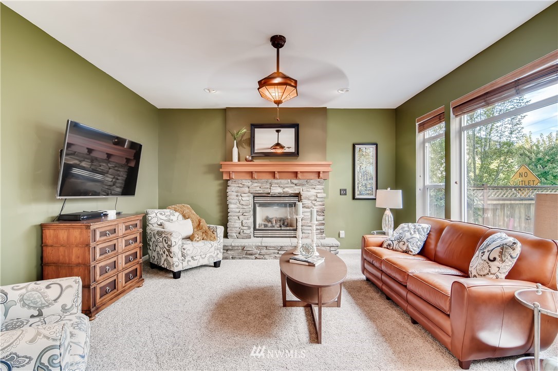 16530 Parkside Way Southeast Renton, WA 98058 - Photo 11 of 25 a living room with furniture fireplace and a large window