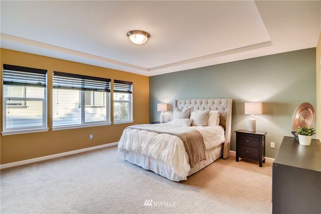 16530 Parkside Way Southeast Renton, WA 98058 - Photo 13 of 25 a spacious bedroom with a bed and large windows