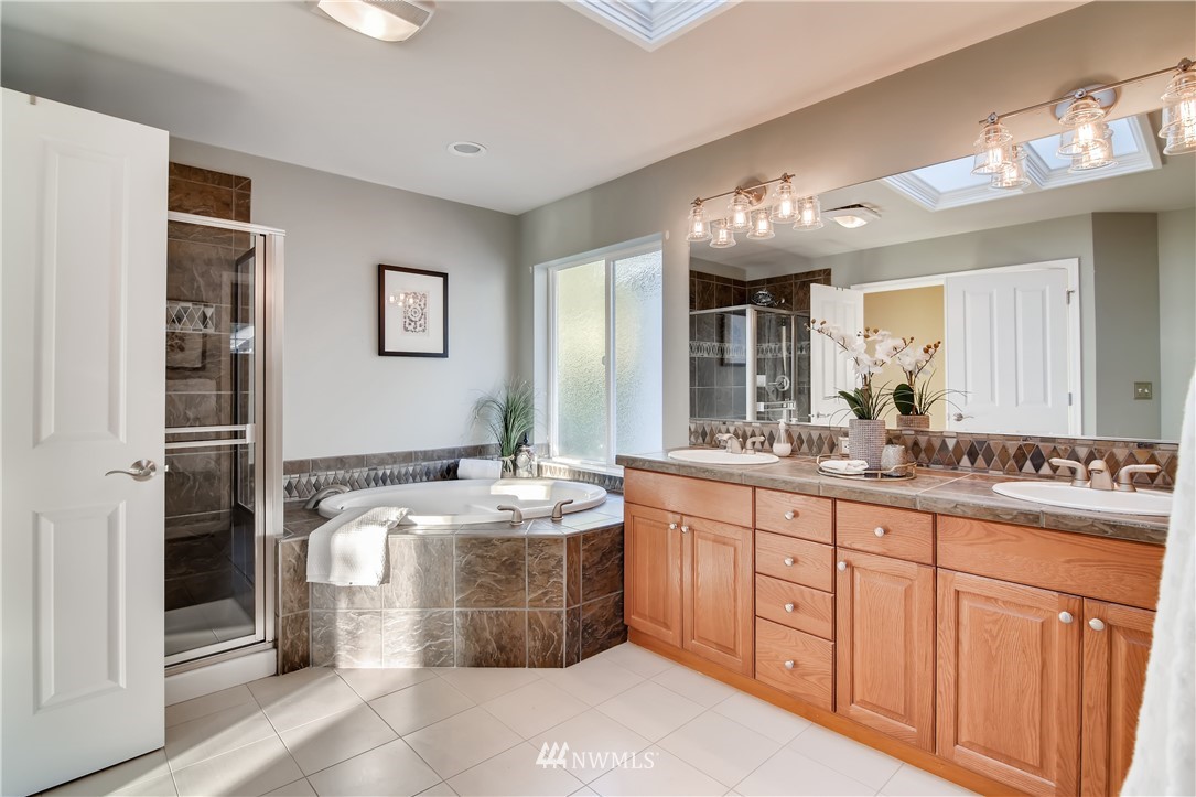 16530 Parkside Way Southeast Renton, WA 98058 - Photo 18 of 25 a bathroom with double vanity sink and a mirror