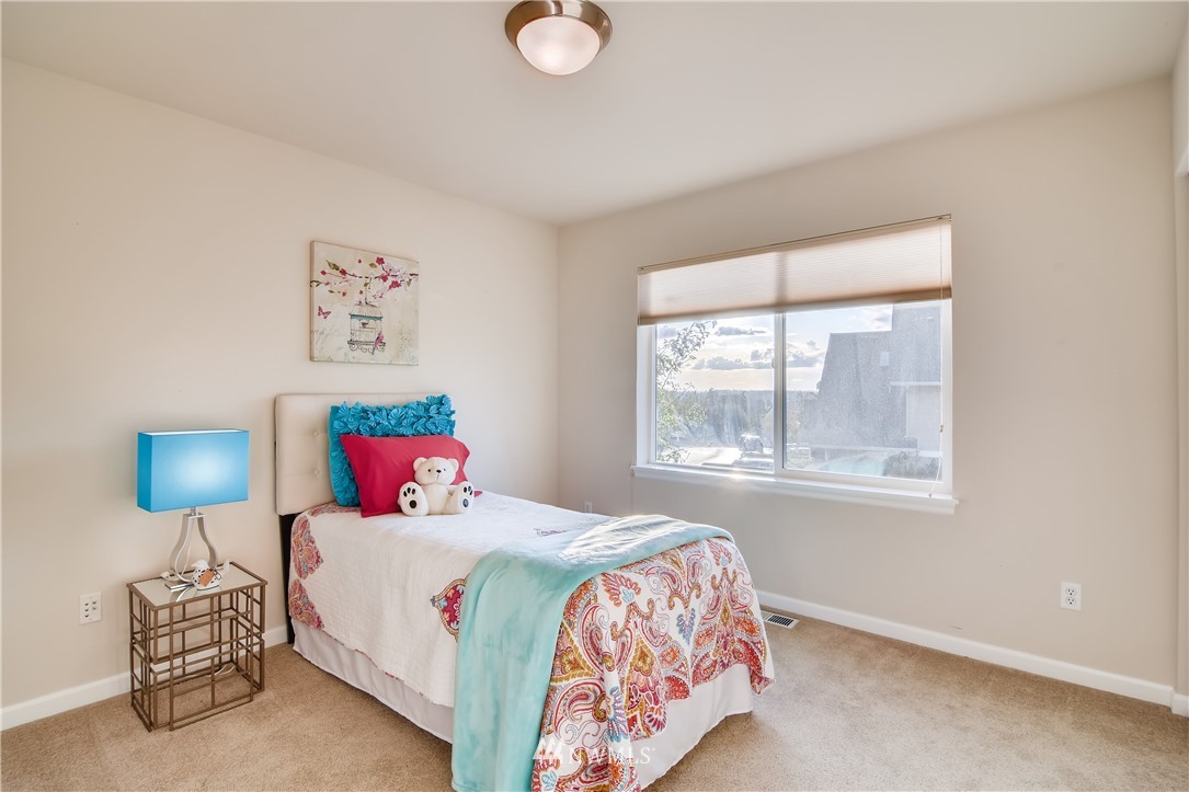 16530 Parkside Way Southeast Renton, WA 98058 - Photo 19 of 25 a bedroom with a bed and a lamp next to a window
