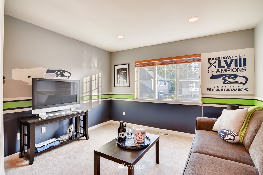 16530 Parkside Way Southeast Renton, WA 98058 - Photo 22 of 25 a living room with furniture and a flat screen tv