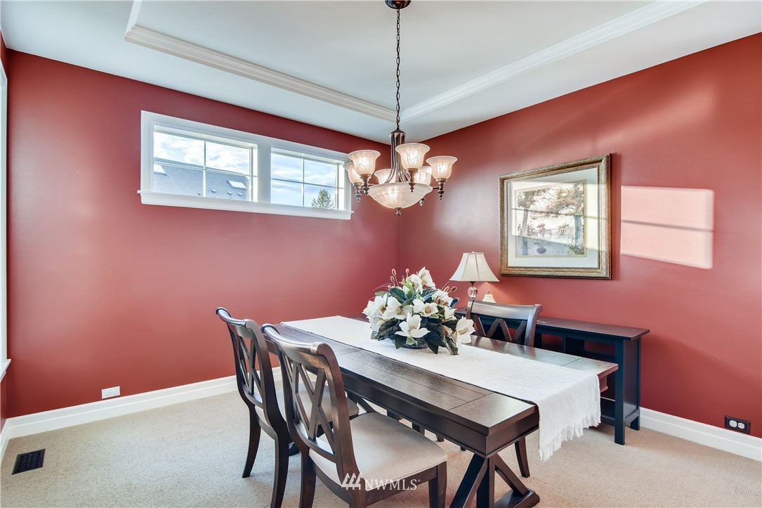16530 Parkside Way Southeast Renton, WA 98058 - Photo 6 of 25 a dining room with furniture and chandelier