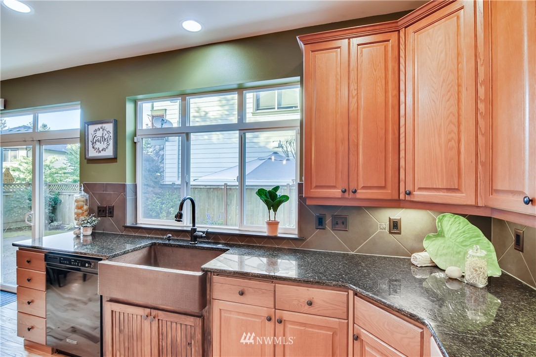 16530 Parkside Way Southeast Renton, WA 98058 - Photo 9 of 25 a kitchen with granite countertop a sink a counter top space and cabinets