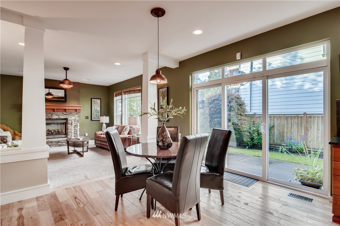 16530 Parkside Way Southeast Renton, WA 98058 - Photo 10 of 25 a dining room with furniture water view and a floor to ceiling window