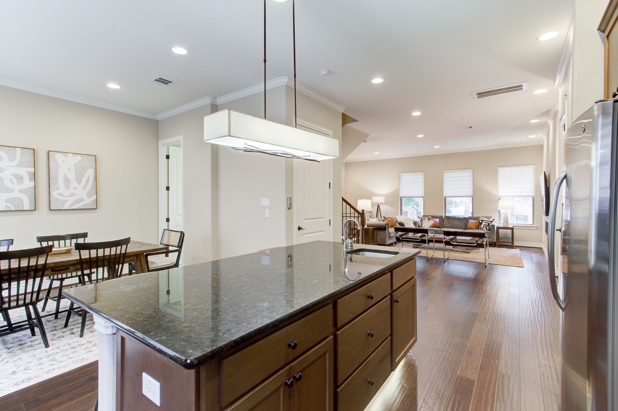 224 Adams Street Georgetown, TX 78628 - Photo 4 of 34 a kitchen with sink a refrigerator and chairs