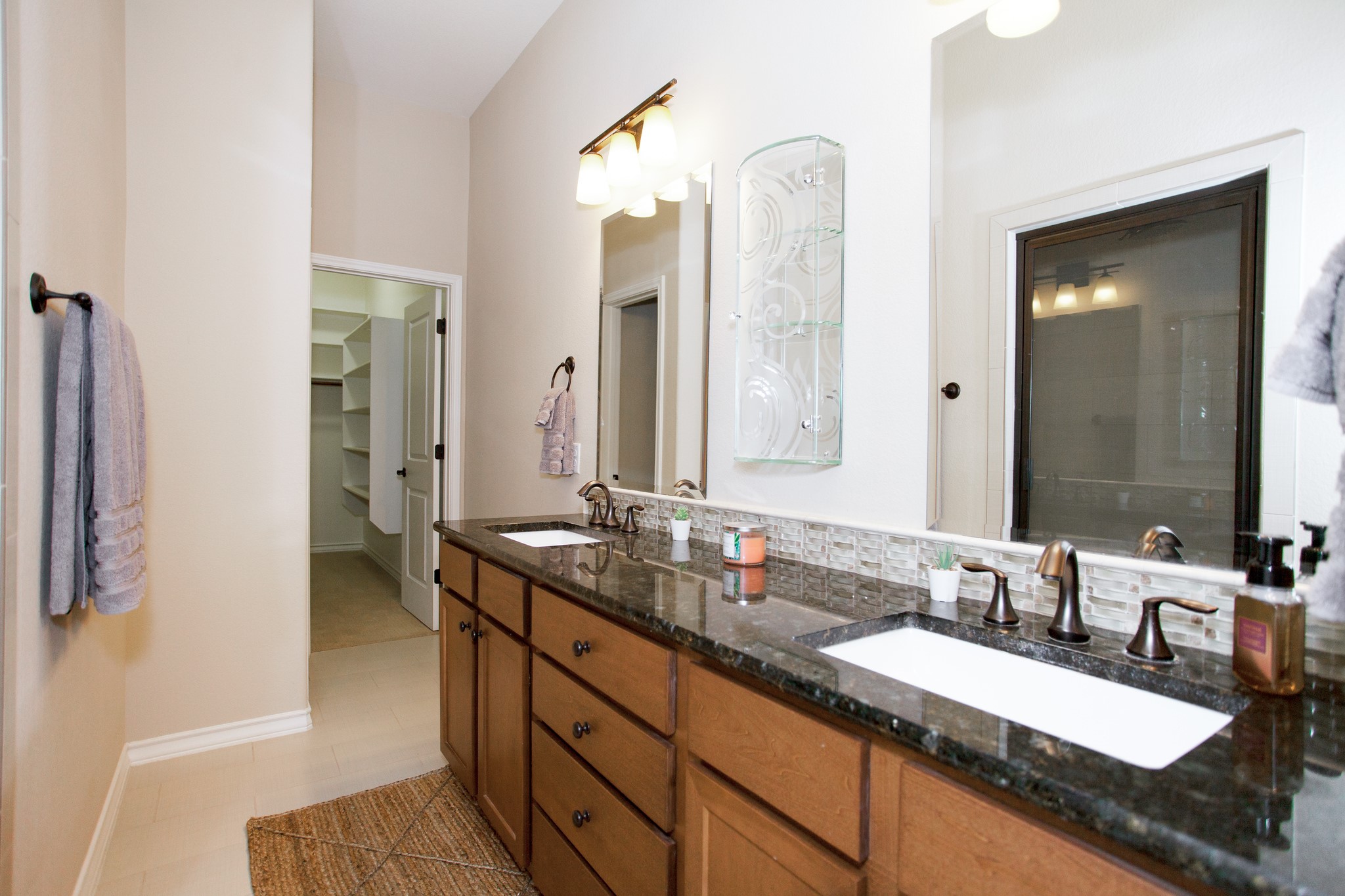 224 Adams Street Georgetown, TX 78628 - Photo 6 of 34 a bathroom with a granite countertop double vanity sink and a mirror