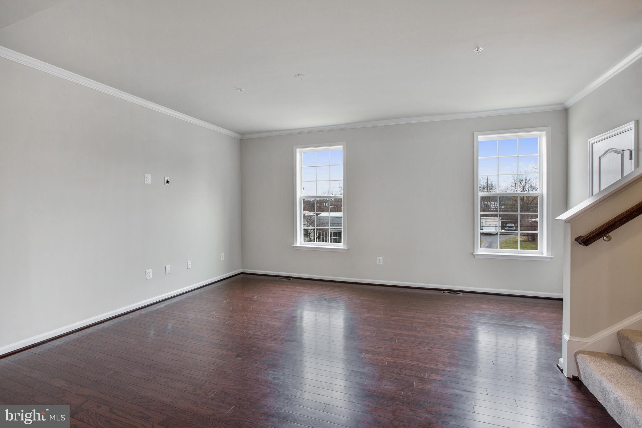 7873 Wormans Mill Road Frederick, MD 21701 - Photo 11 of 30 a view of an empty room with wooden floor and a window