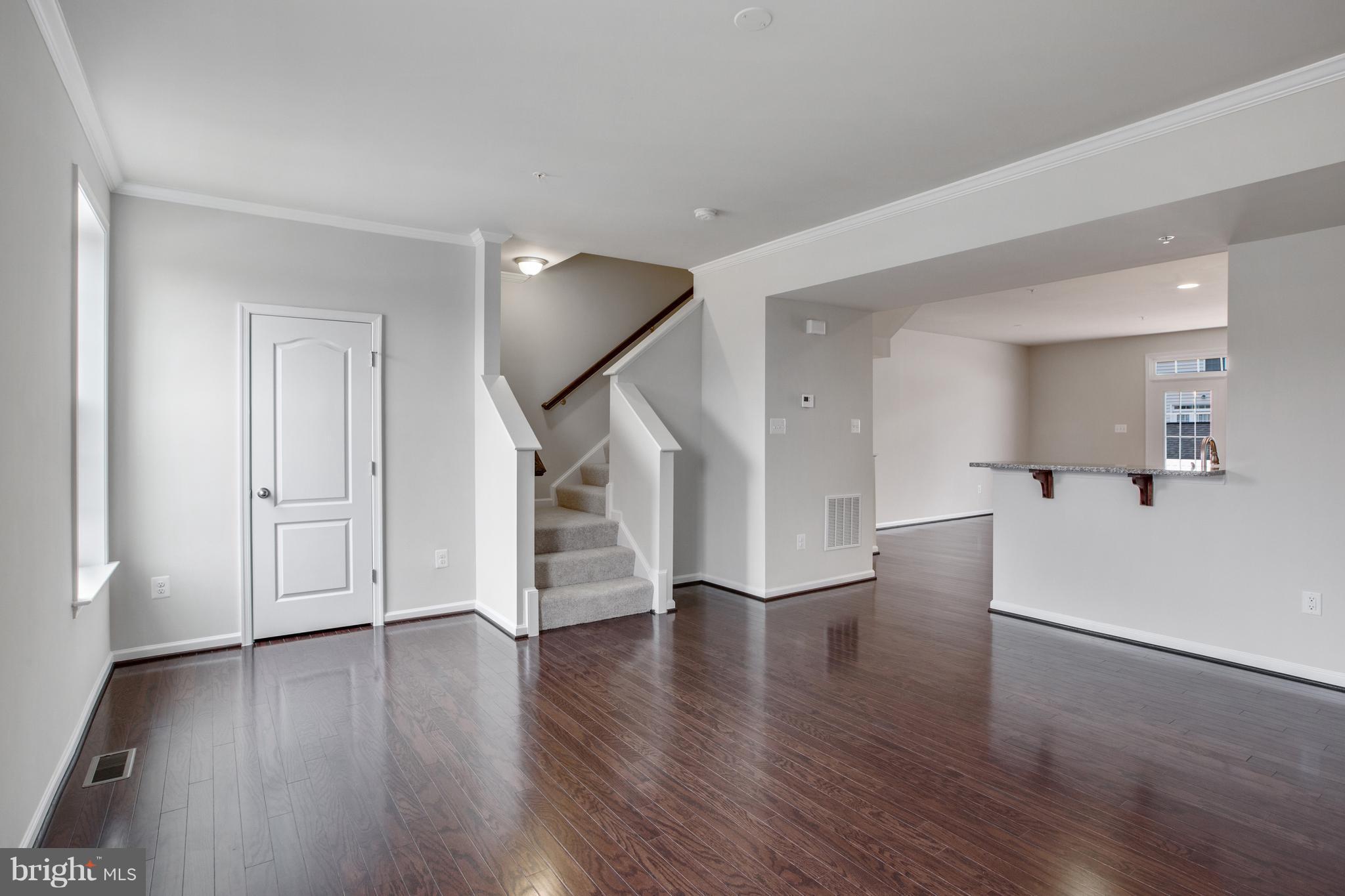 7873 Wormans Mill Road Frederick, MD 21701 - Photo 12 of 30 a view of a hallway with wooden floor and staircase