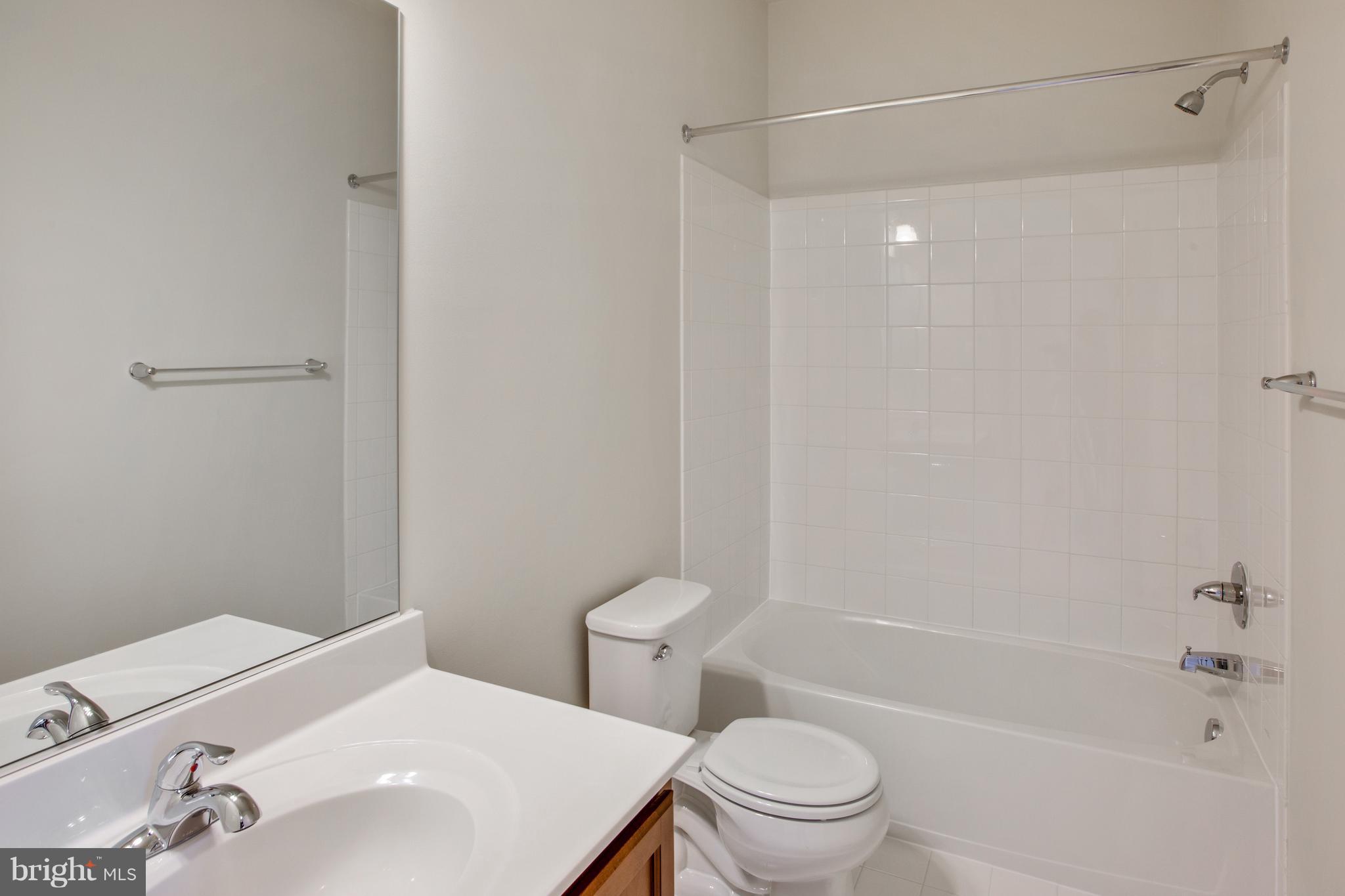 7873 Wormans Mill Road Frederick, MD 21701 - Photo 24 of 30 a bathroom with a sink a toilet and shower