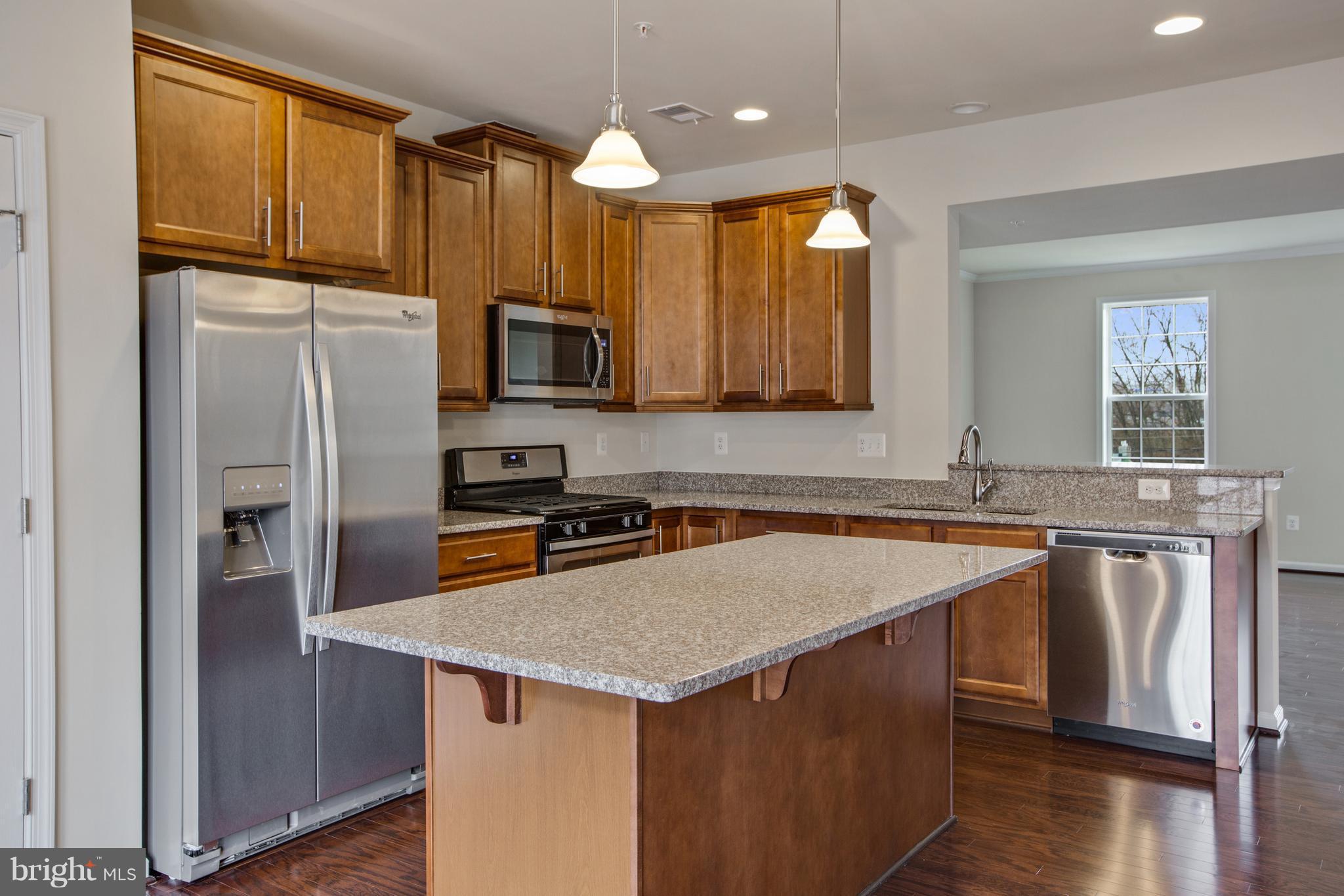 7873 Wormans Mill Road Frederick, MD 21701 - Photo 9 of 30 a kitchen with stainless steel appliances granite countertop a sink stove and refrigerator