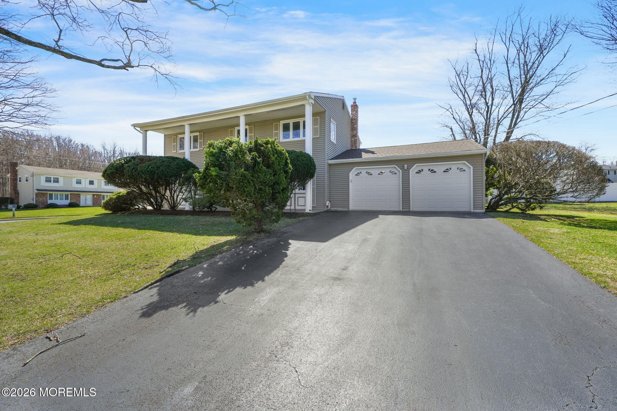 a view of a house with a yard and garage