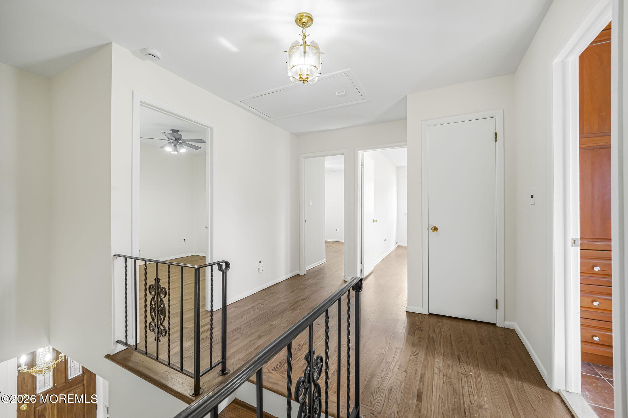 1 Sudbury Road Morganville, NJ 07751 - Photo 22 of 43 a view of a hallway with wooden floor and staircase