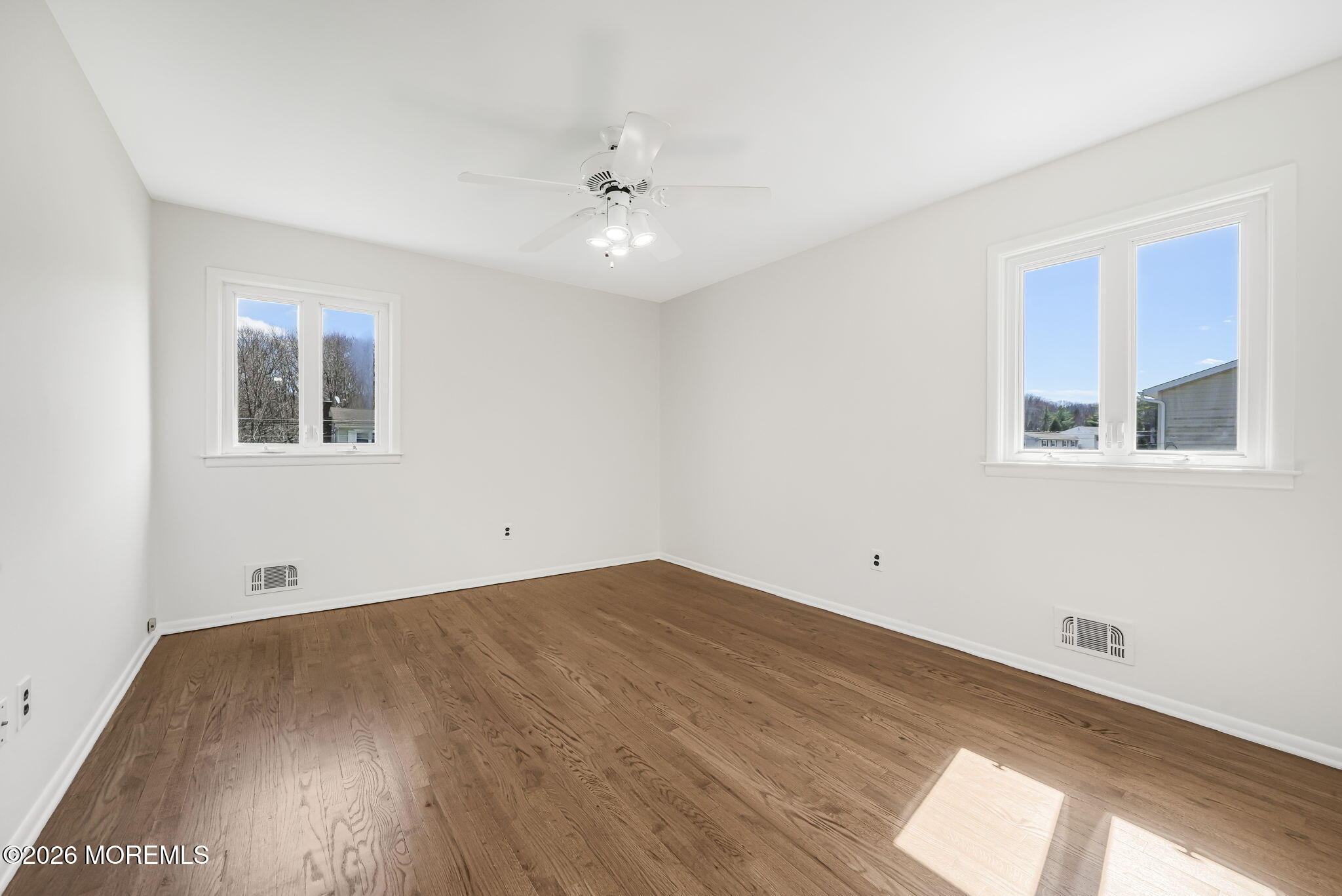 1 Sudbury Road Morganville, NJ 07751 - Photo 31 of 43 a view of empty room with wooden floor and fan