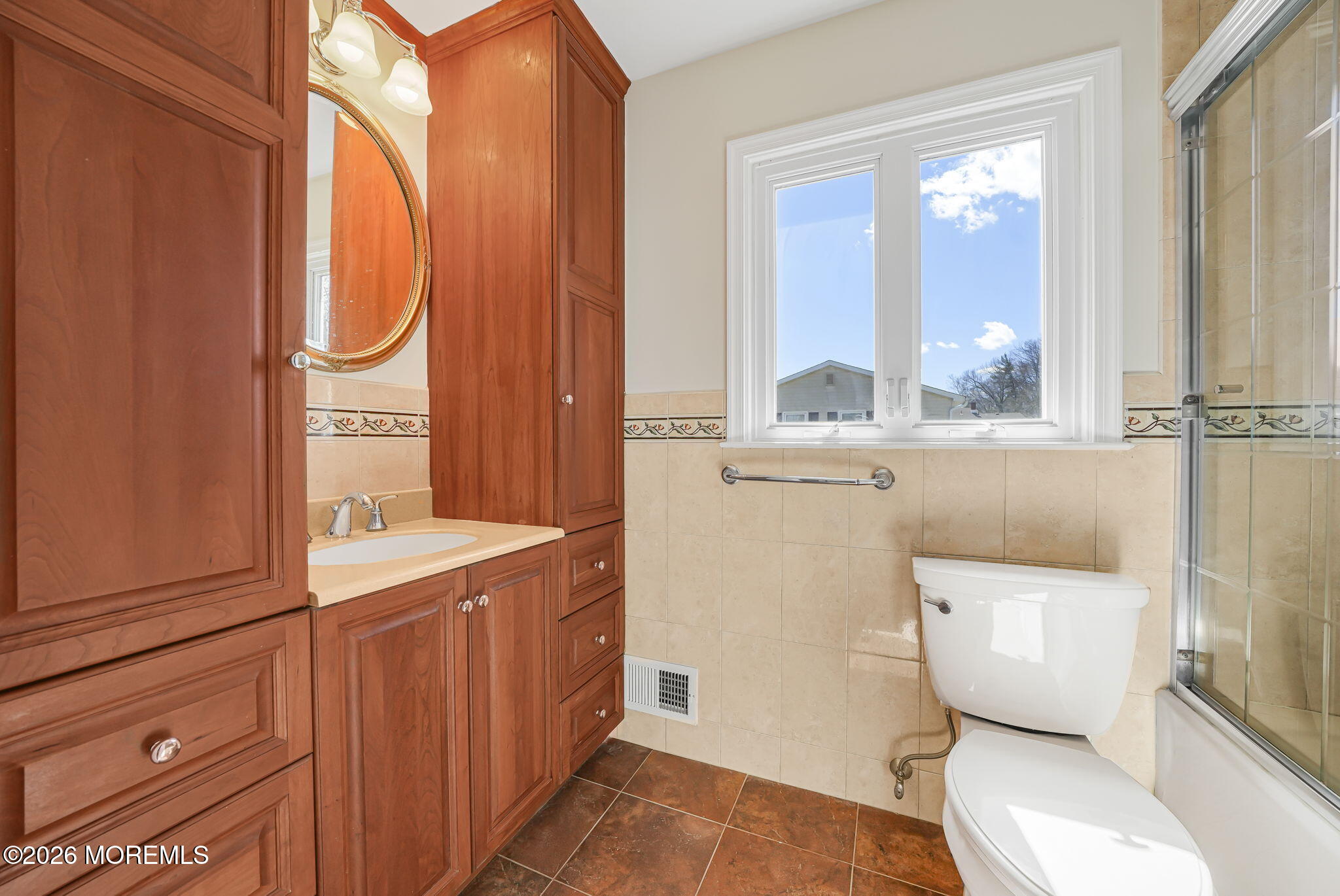 1 Sudbury Road Morganville, NJ 07751 - Photo 32 of 43 a bathroom with a toilet a sink and a mirror